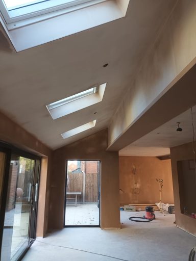 Skilled plasterer mid‑job, delivering a solid, clean render backed by years of graft and real trade expertise.